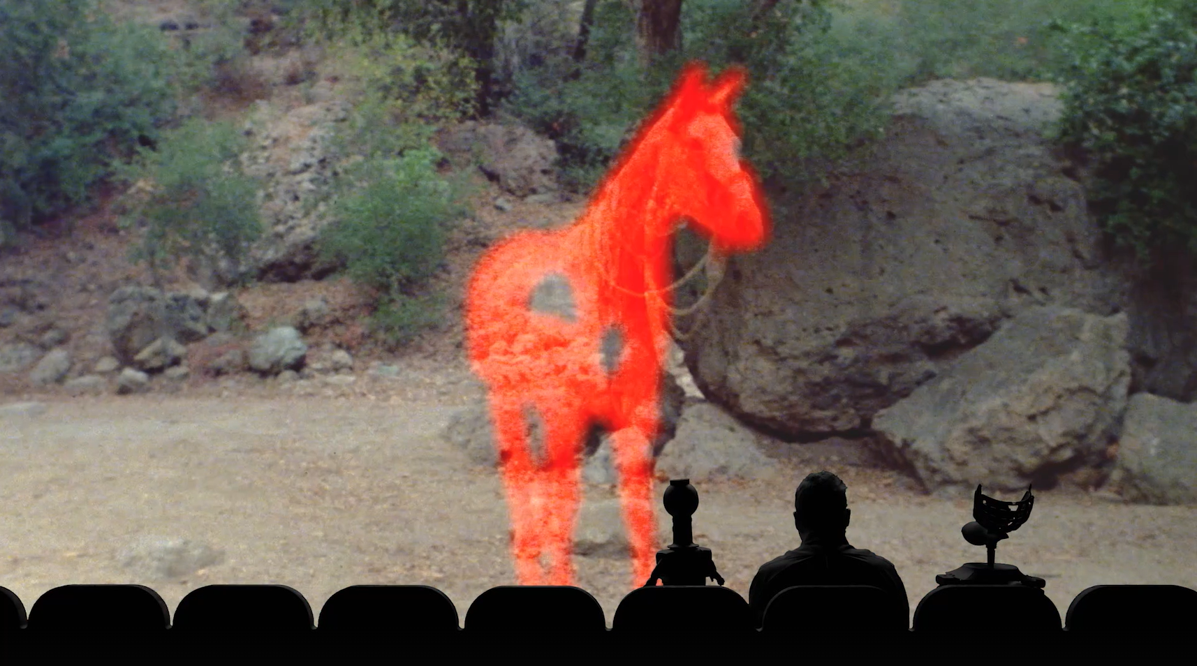 A red horse standing in a rocky landscape